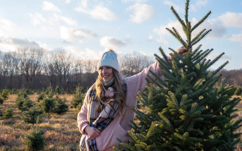 a woman beside a balsam fir