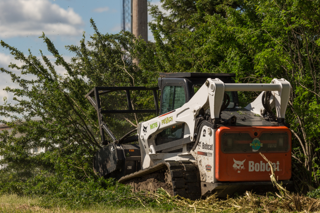 Bobcat mulching trees & shrubs while perfoming vegetation management