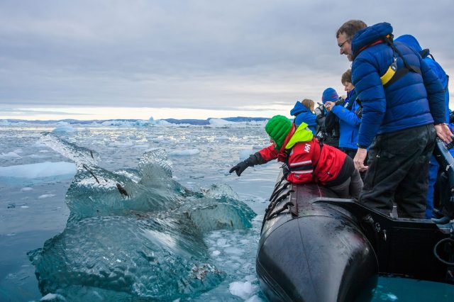 Zodiac cruise in ice guest pointing