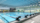 Pool side with corridors. Empty pool looking refreshing. Public pool that looks well maintained. Parks and recreation activities.