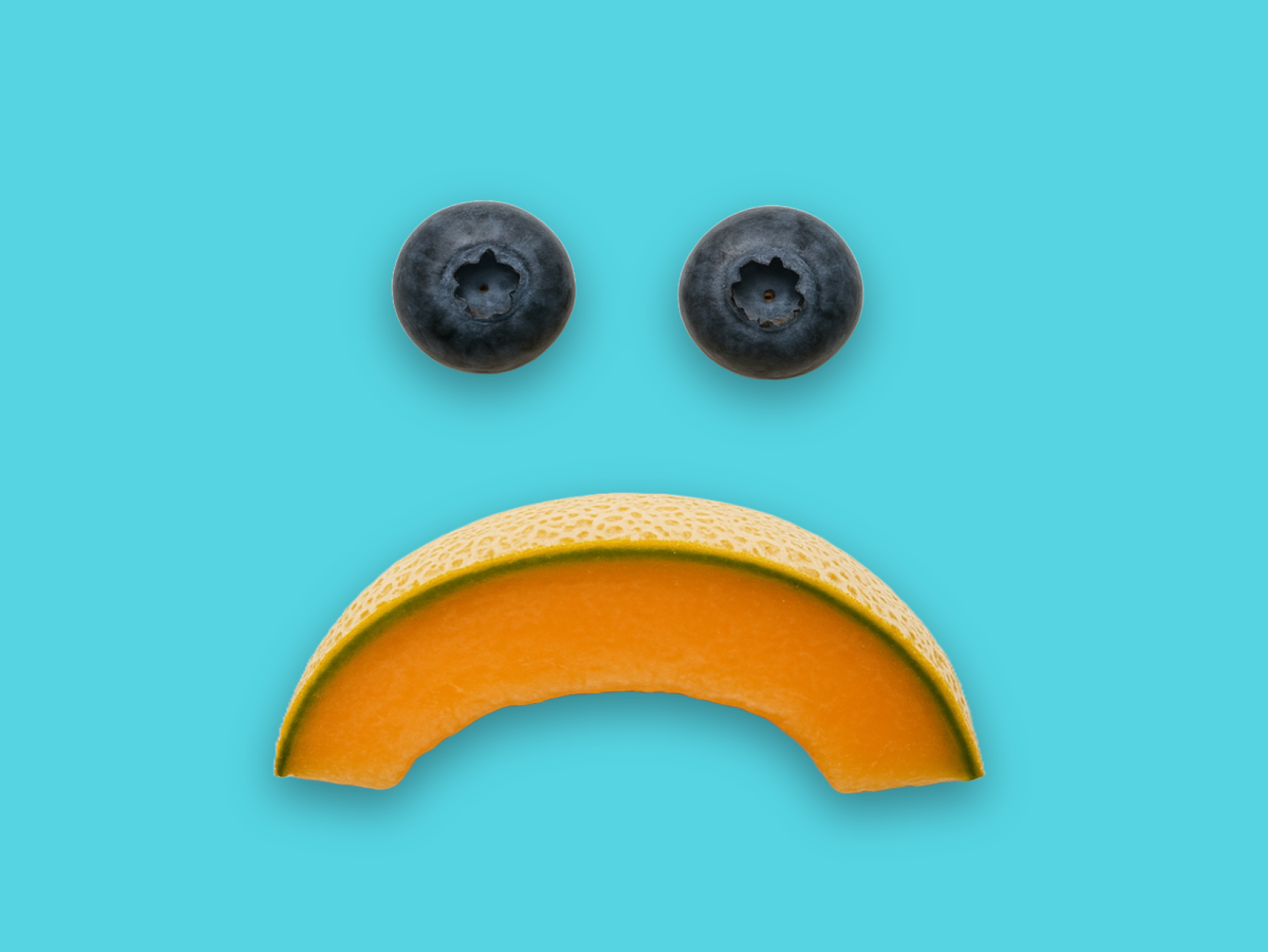 Back-to-school 2025 campaign – fruits arranged to represent a sad face.