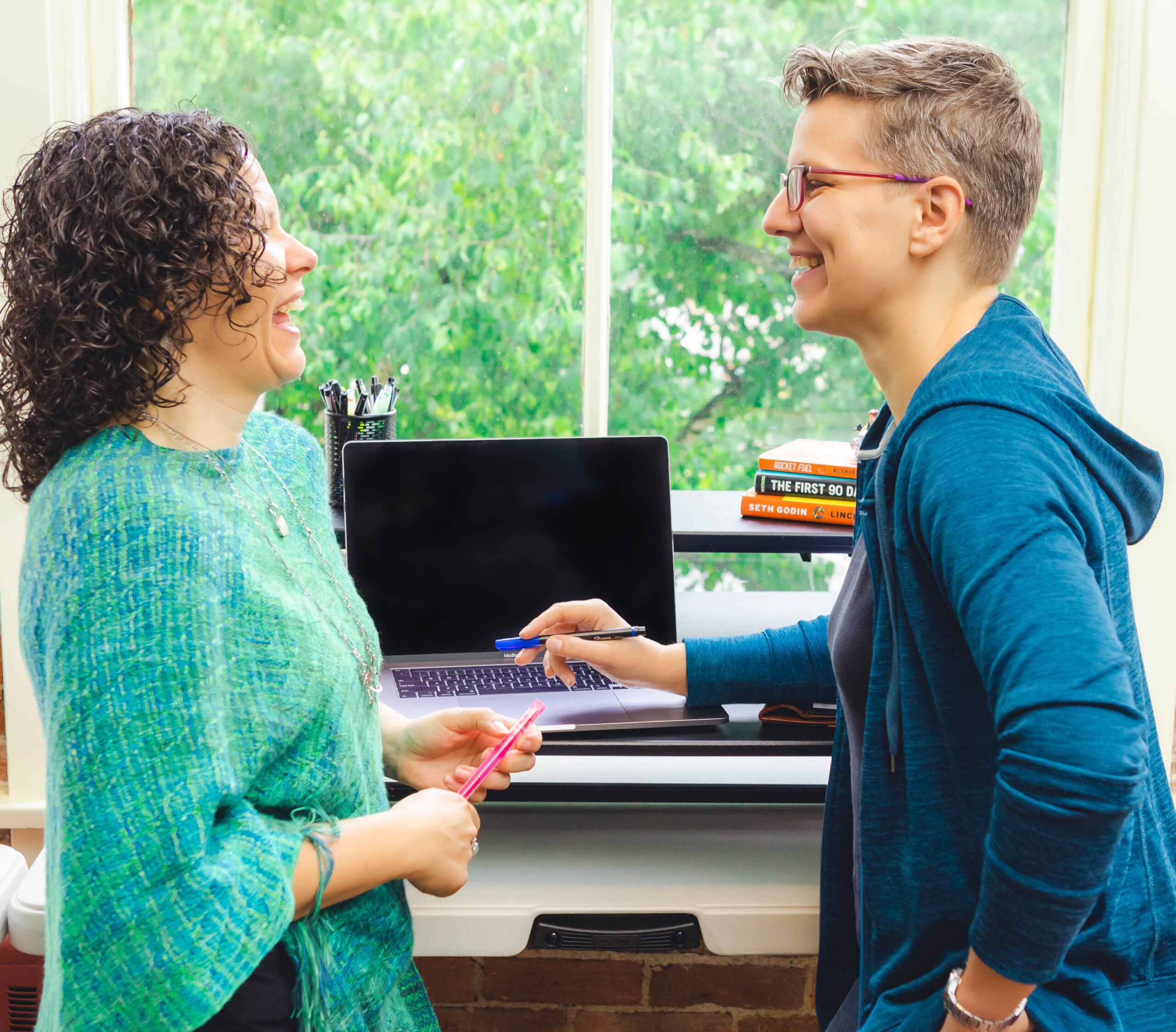Jill stands to the left with Breanne to the right. They are both laughing.