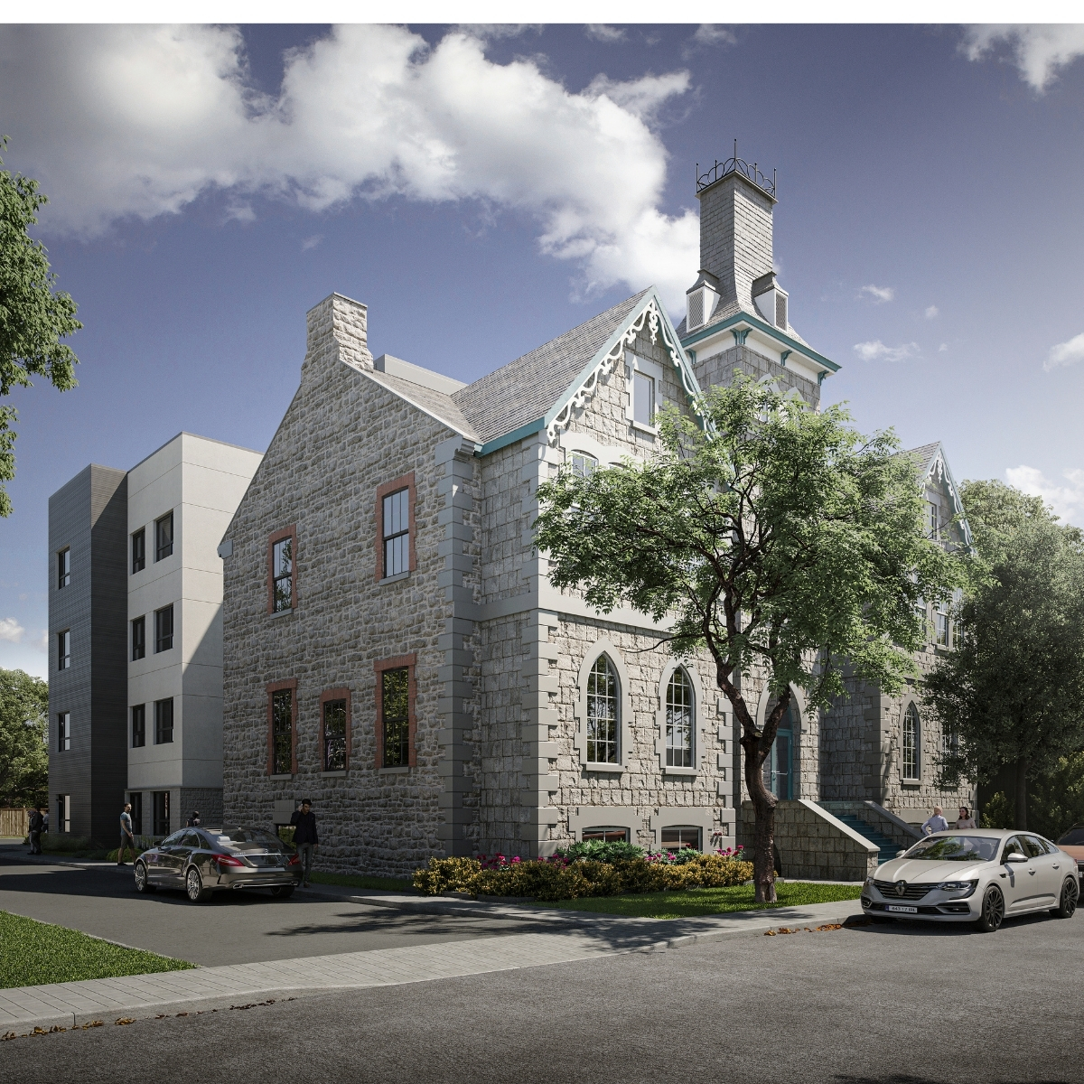 A historic grey stone house with intricate woodwork around the roofline, and a modern apartment building in grey and white stone built onto the back. 
