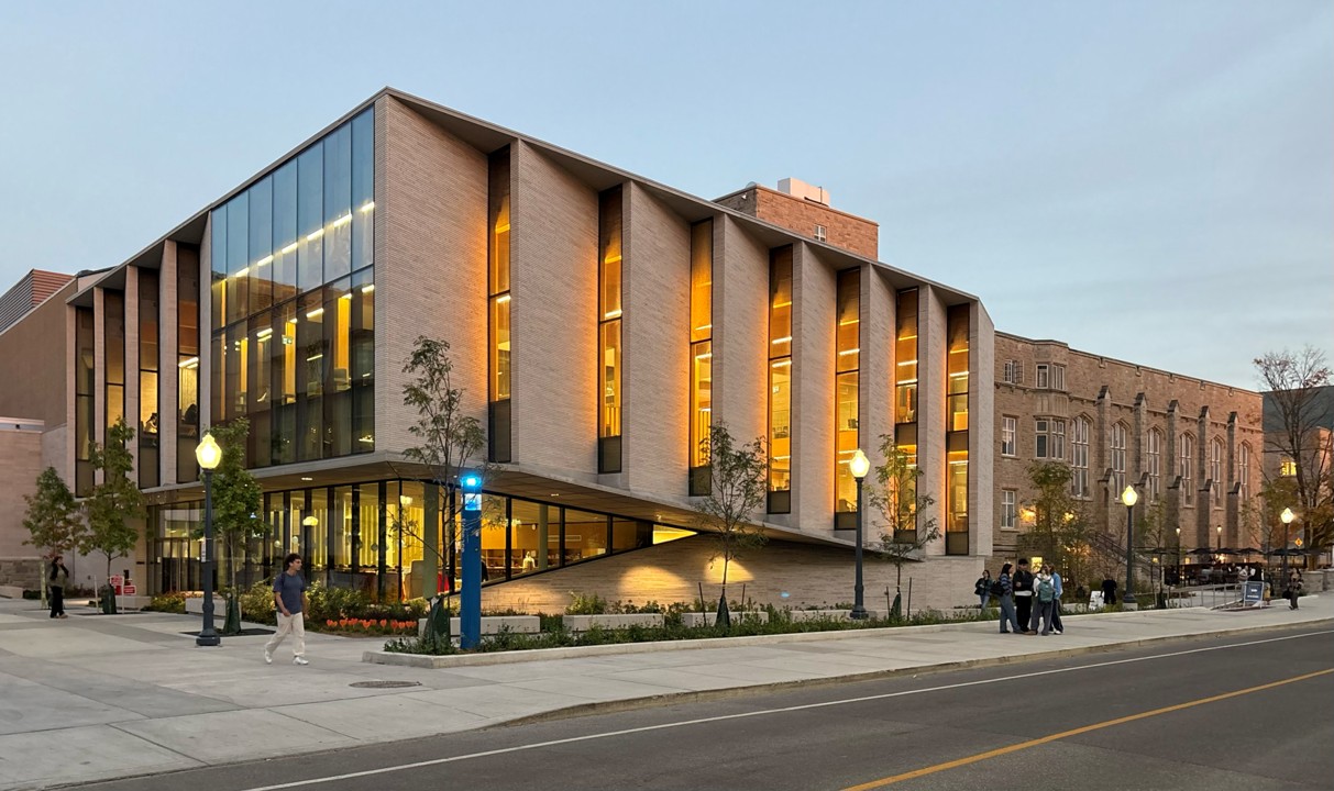 The newly-renovated John Deutch University Centre at Queen's University, with angled window panels and a brick and glass facade. 