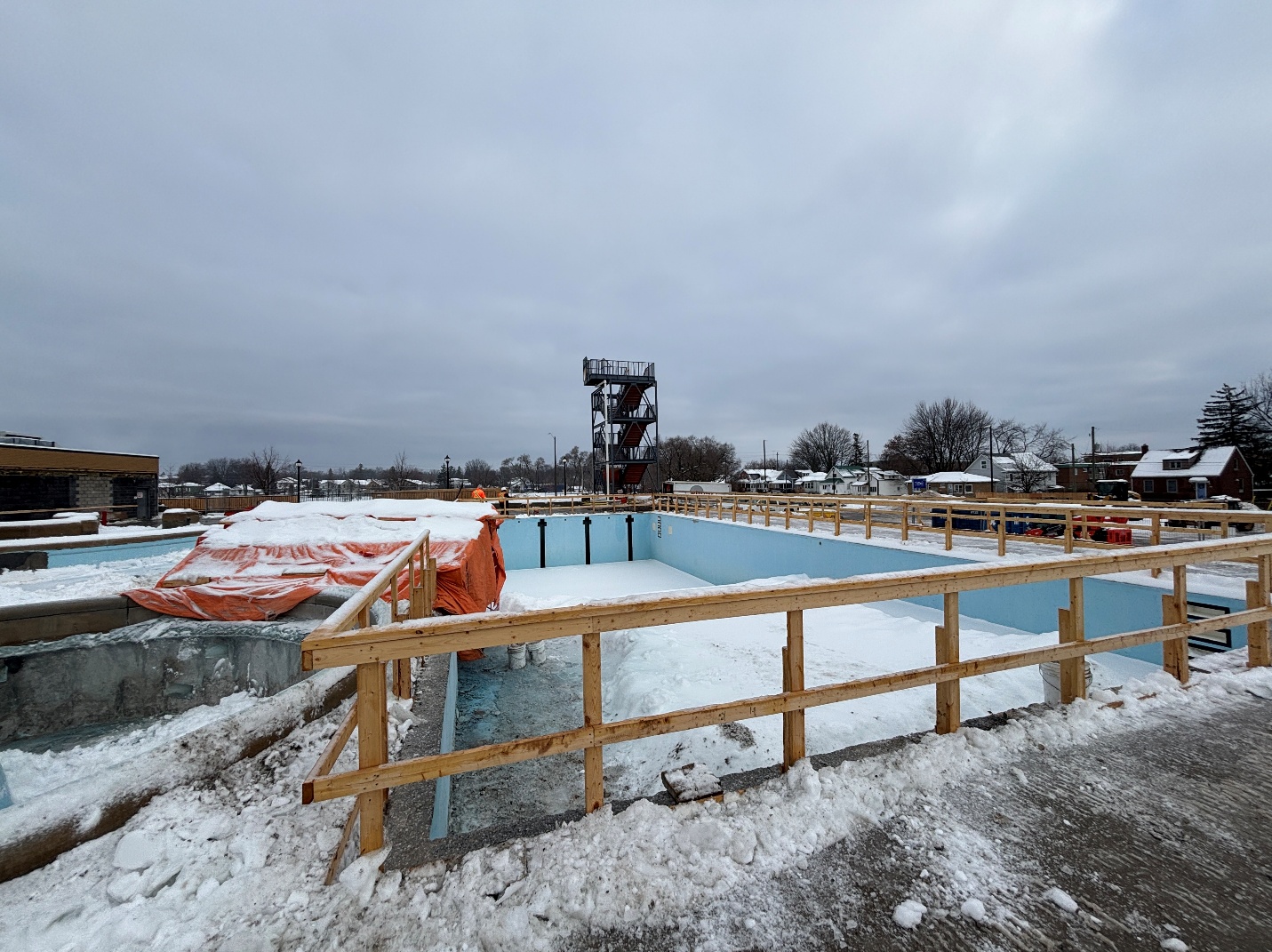 View from South of lap pool. Perimeter copings are removed and guards in place.
