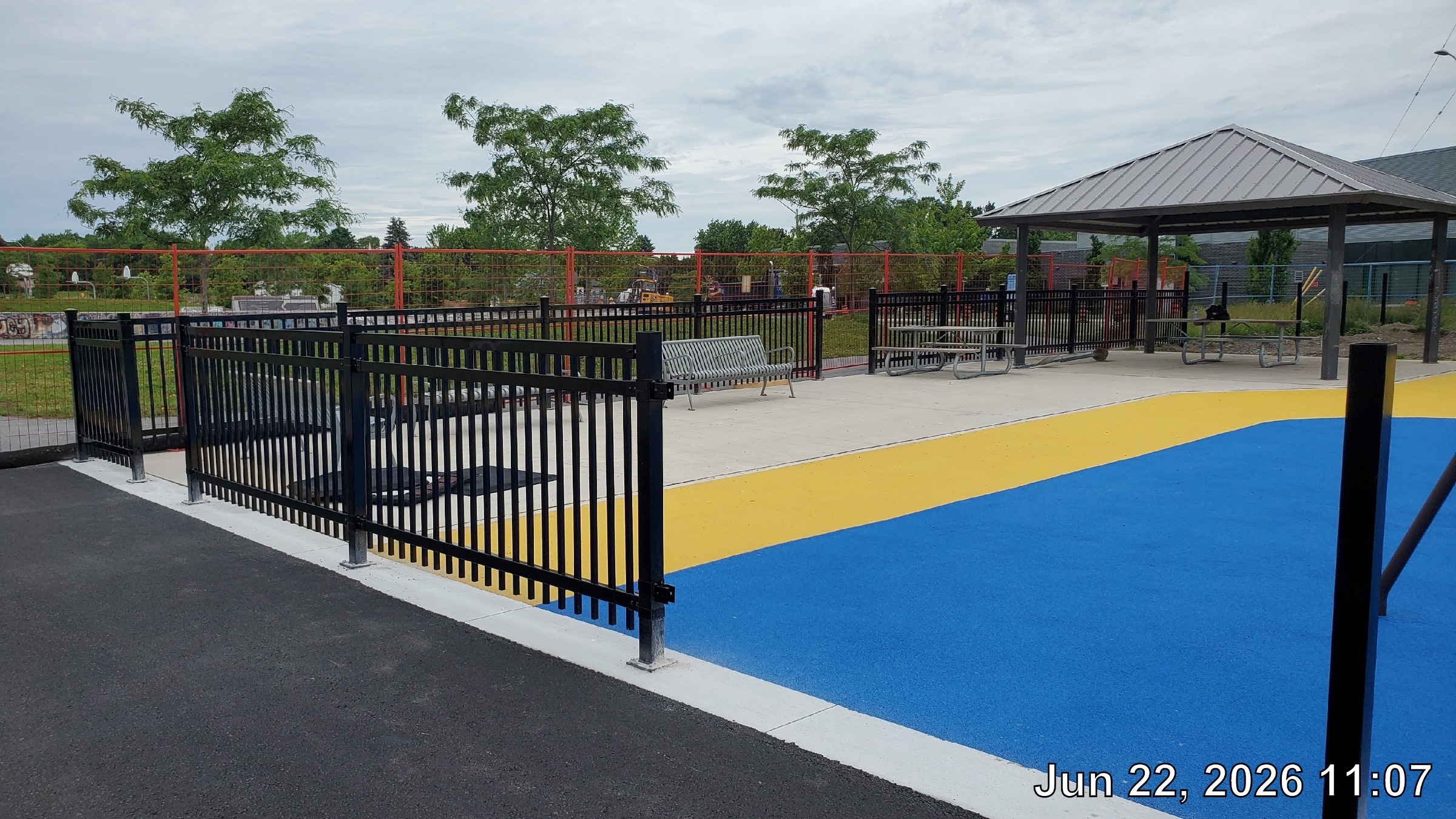 Completed portions of the playground fence are shown.