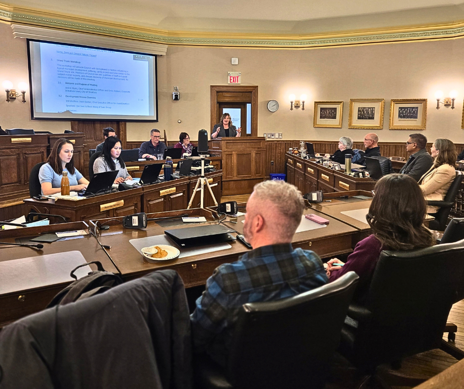 City Council and staff attend the first Grand Trunk workshop on January 27, 2006. Councillors are seated at their desks in the Chamber watching a presentation by a staff member. Photo by Melanie Reasbeck, investStratford. Used with permission.