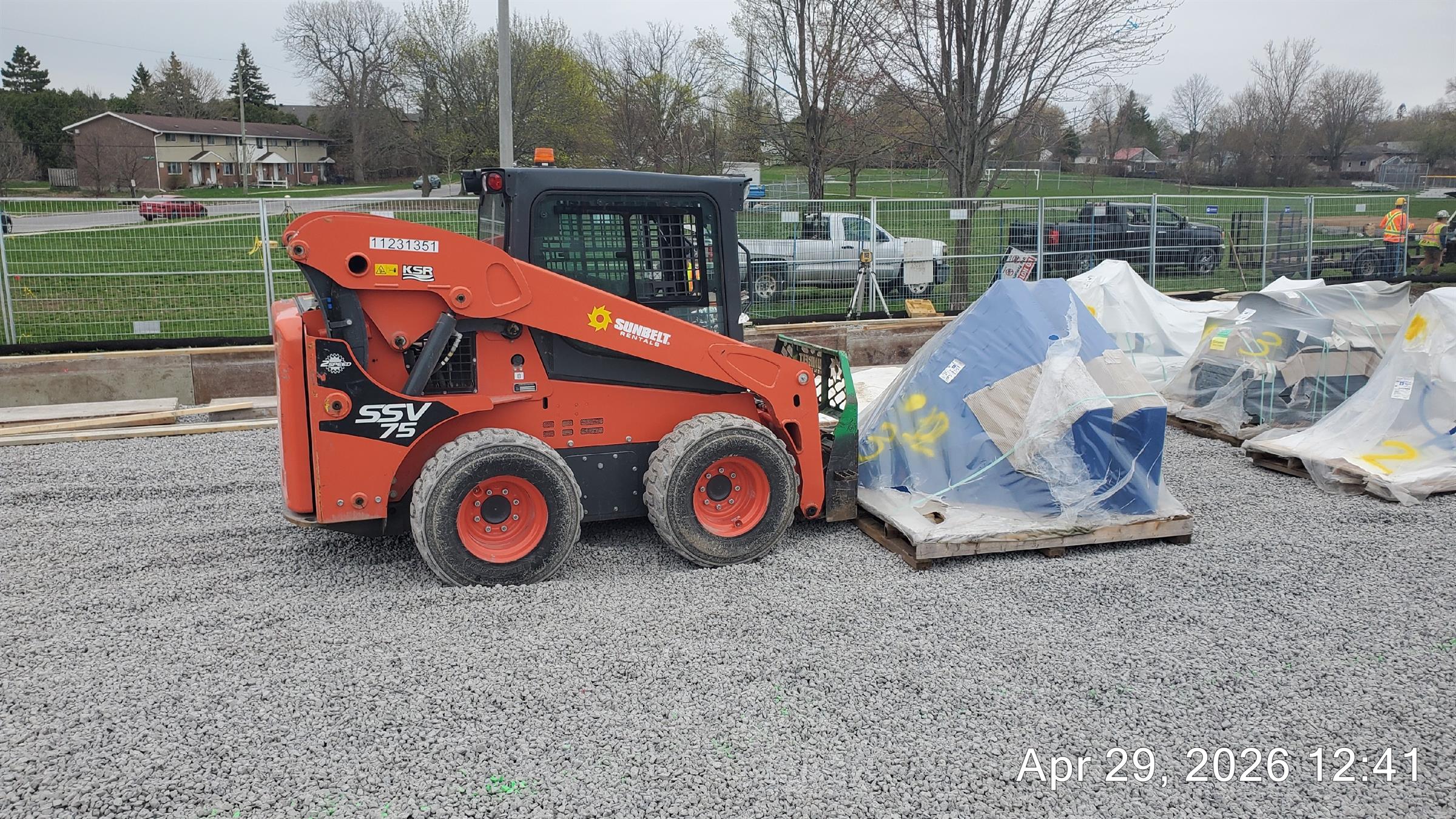 A forklift moving playground equipment