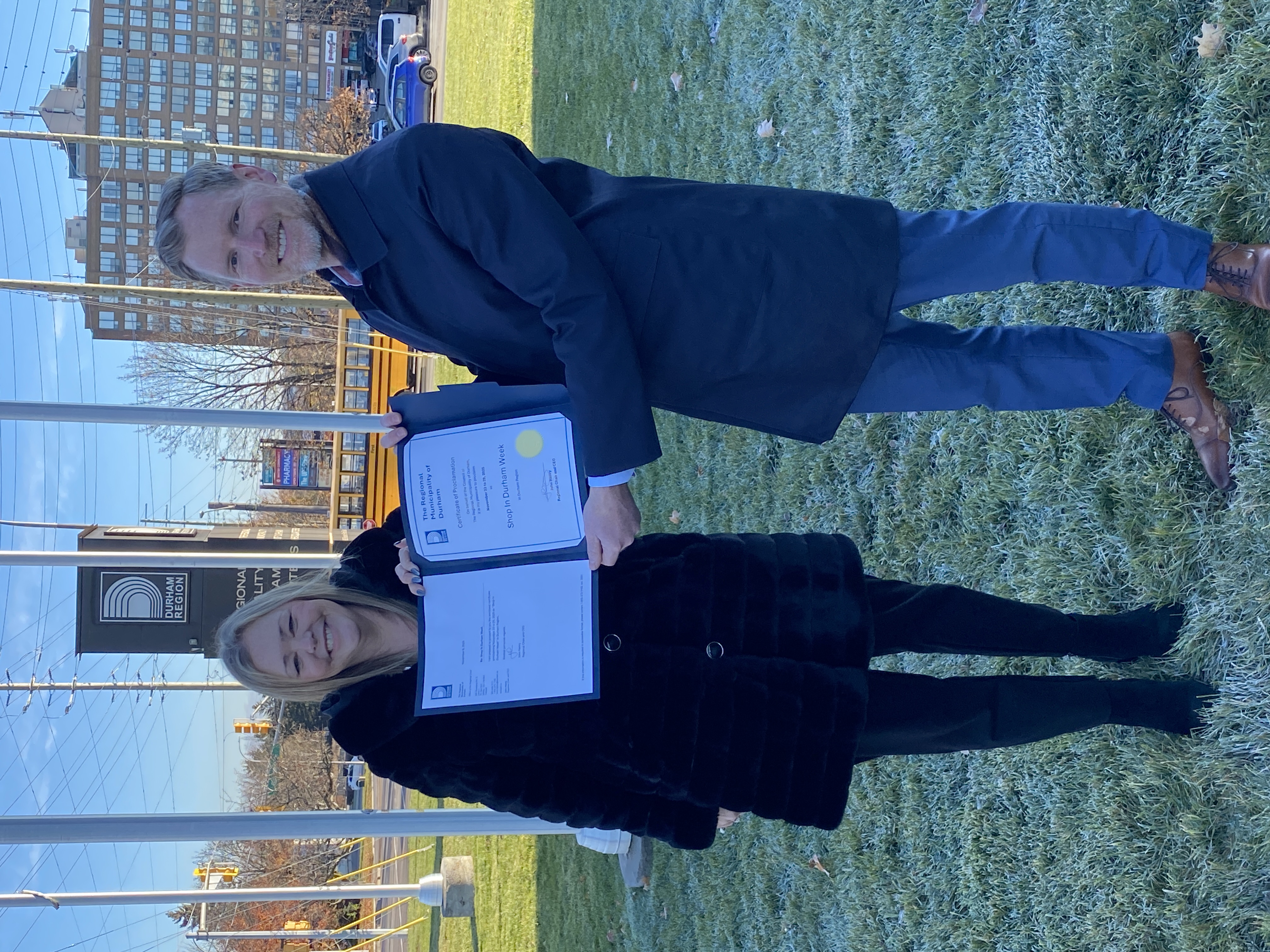 Regional Counillor Rhonda Mulcahy presenting Simon Gill, Director, Invest Durham & Durham Tourism, with a Shop in Durham Week proclamation certificate.