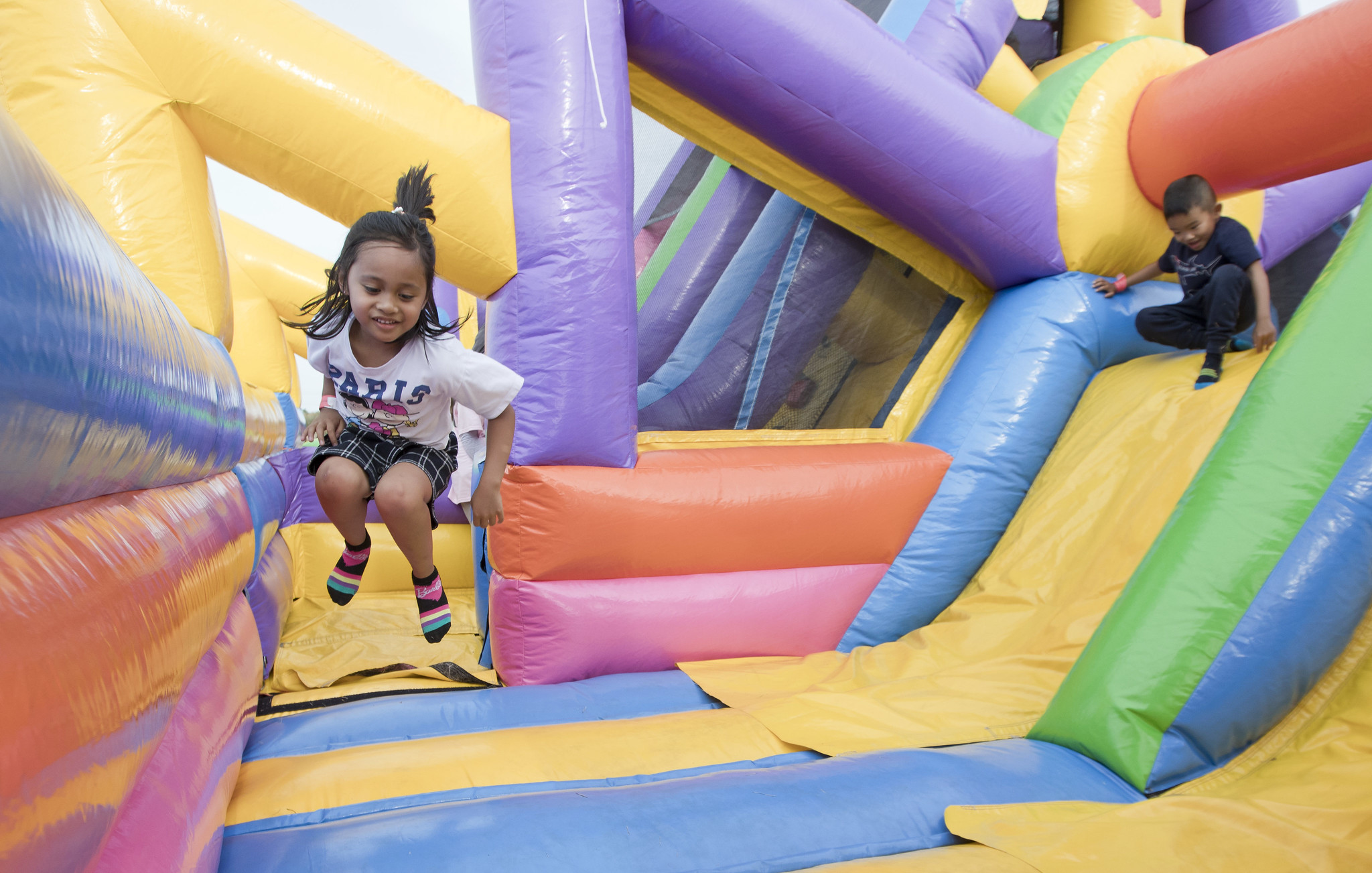 Child playing in inflatable slide.