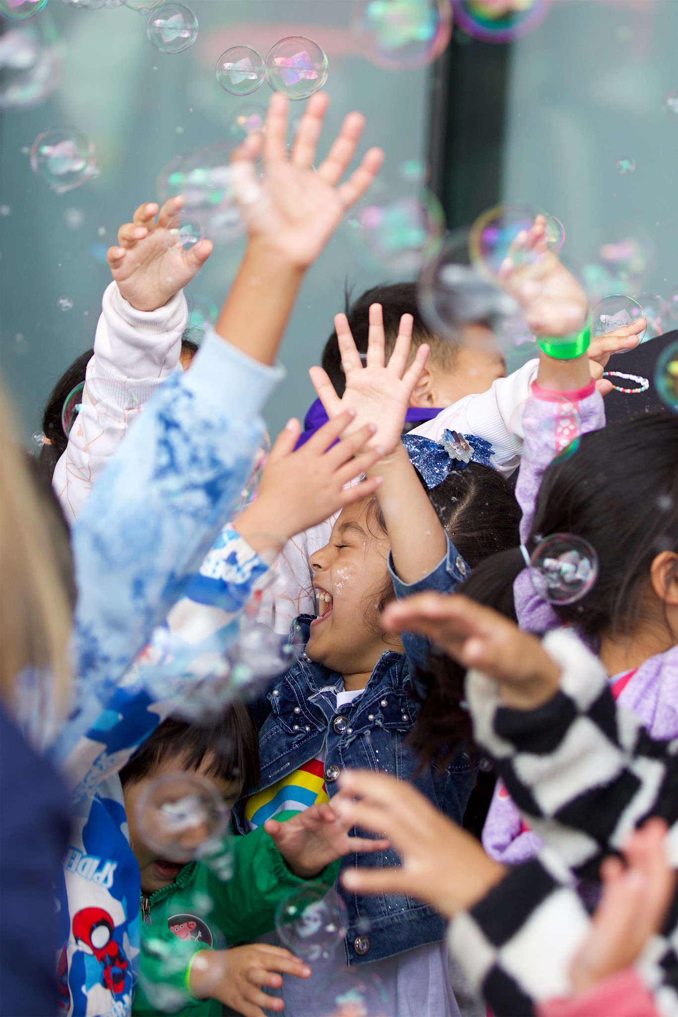 A group of children playing with bubbles.