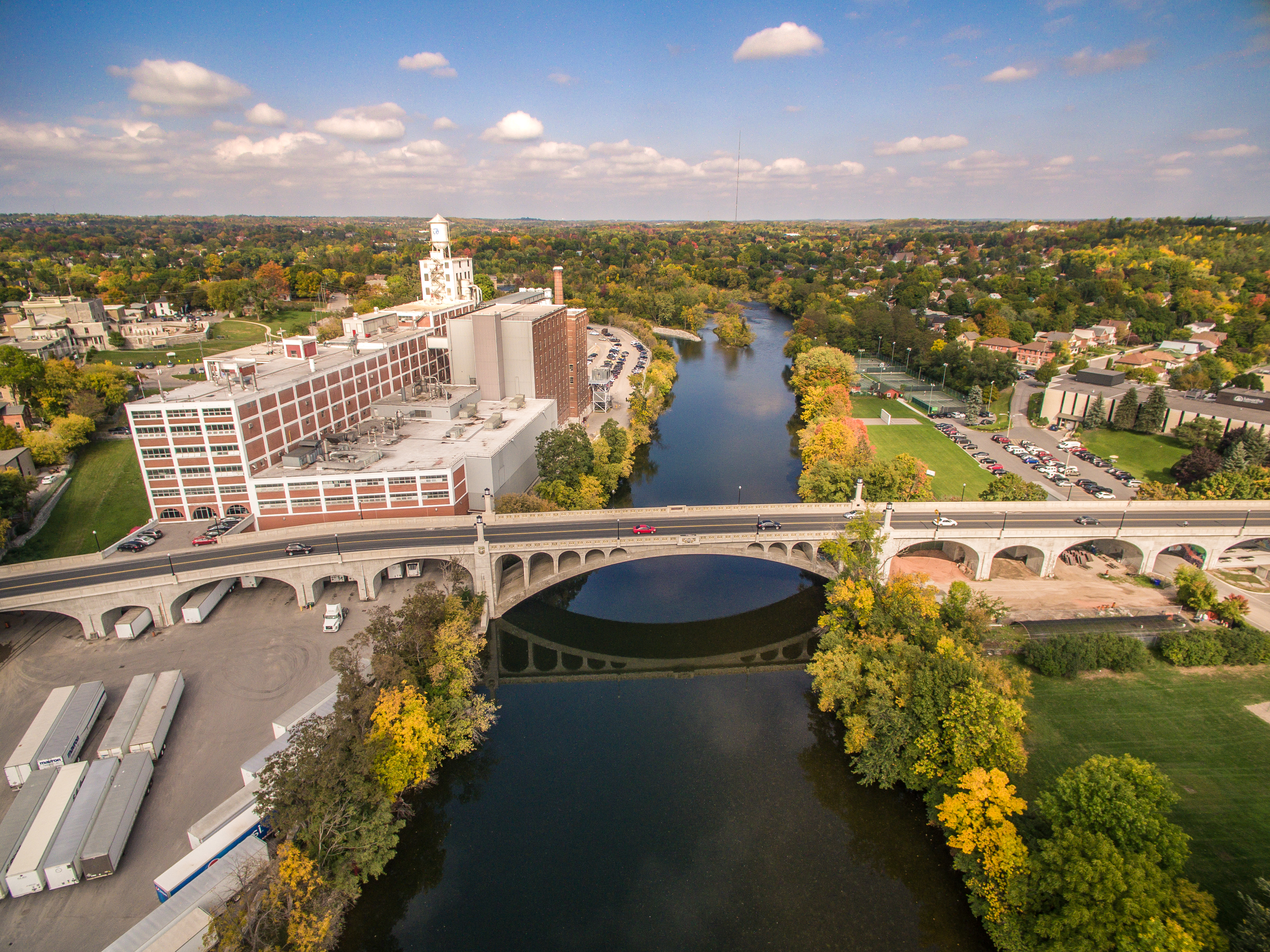 aerial shot of a river with buildings on either side