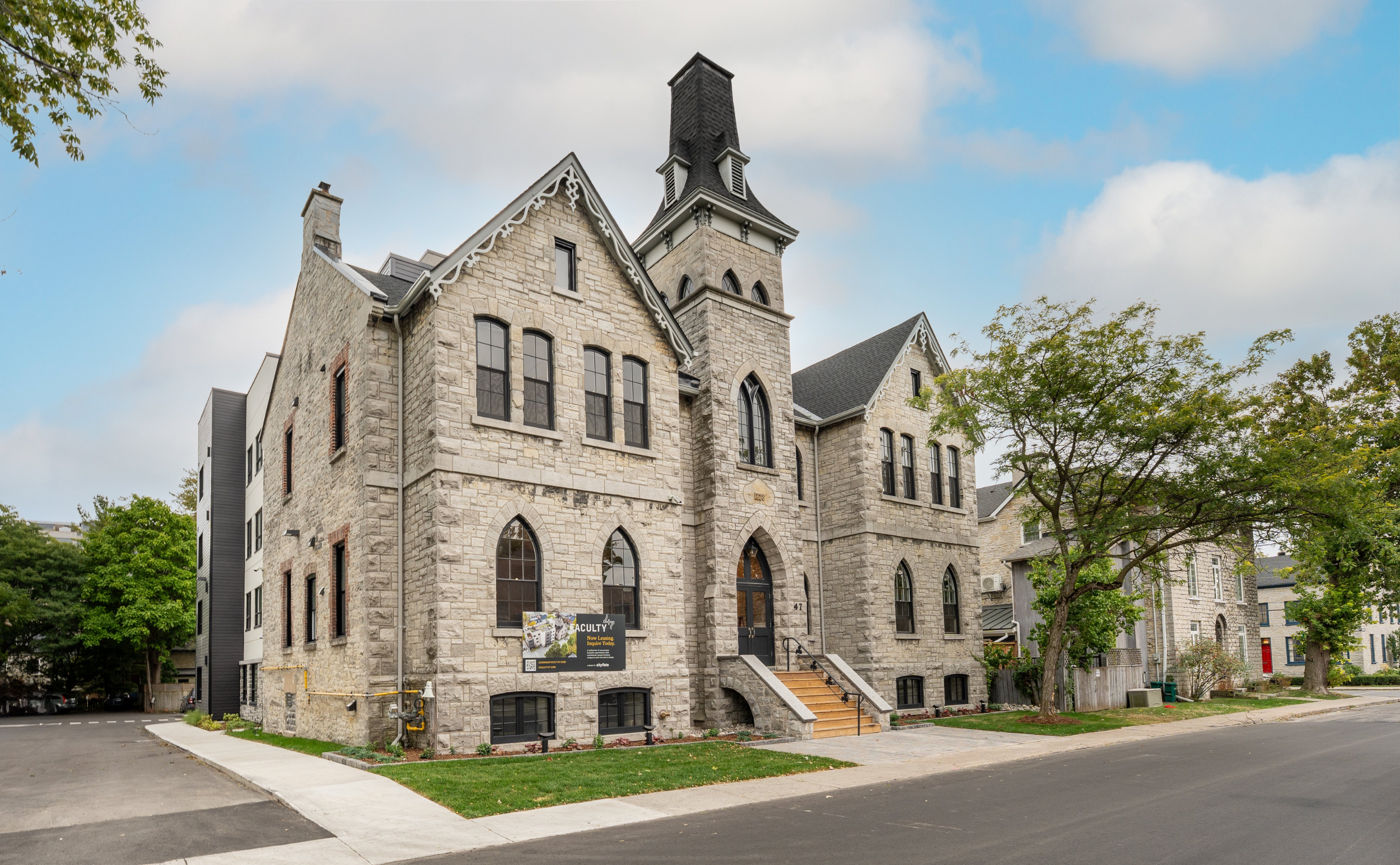 Factory 47 - an old limestone school building with modern apartments in behind.