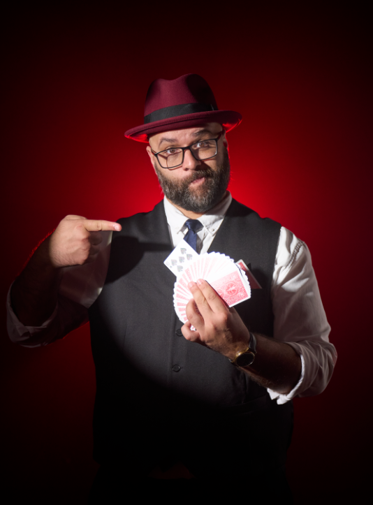 Arieze Kanji holding a deck of cards.