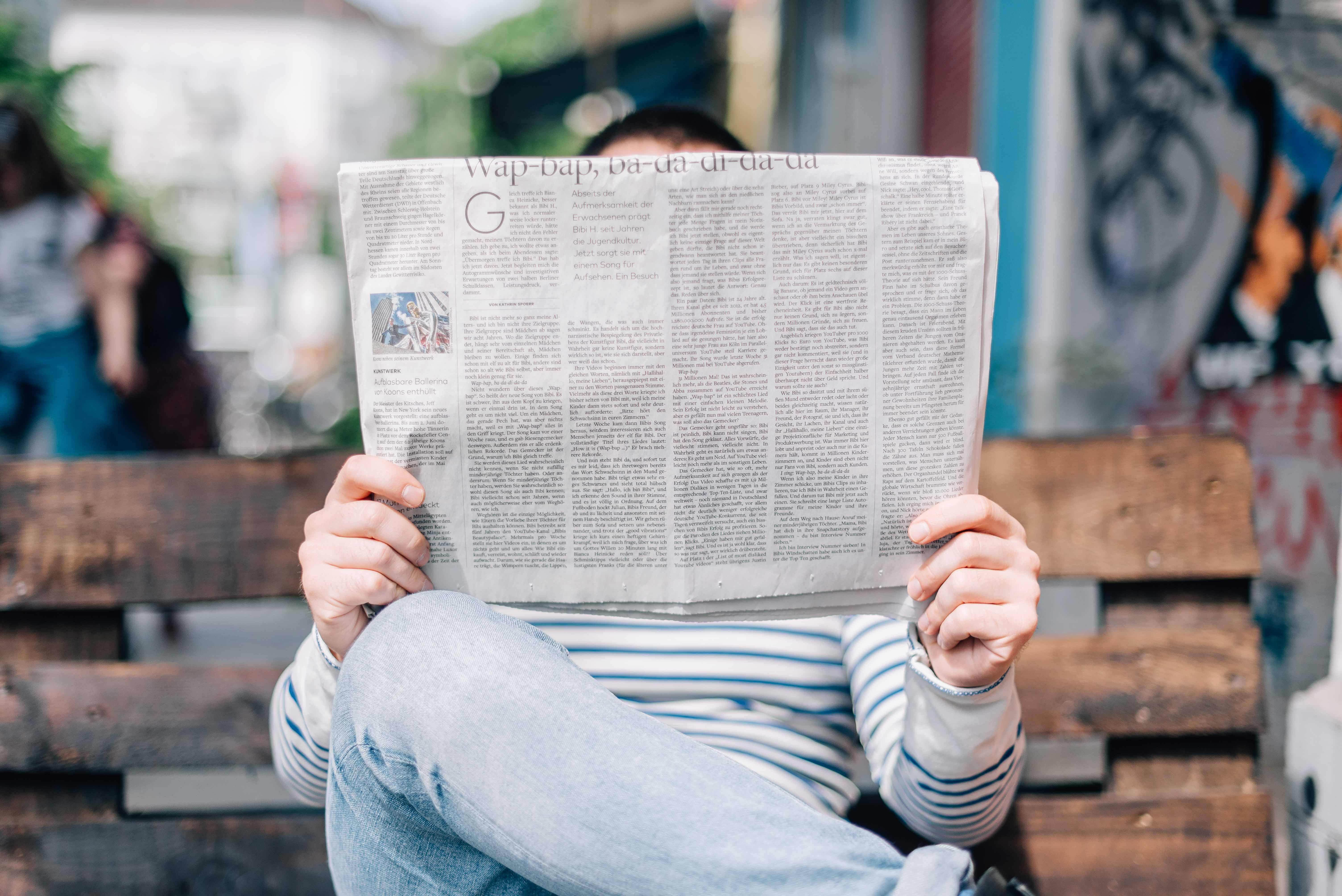Guy reading paper