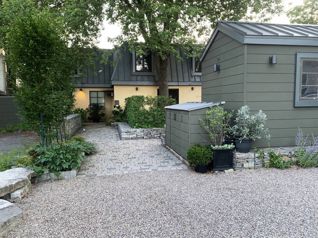 Two renovated homes, one yellow and one gray-green