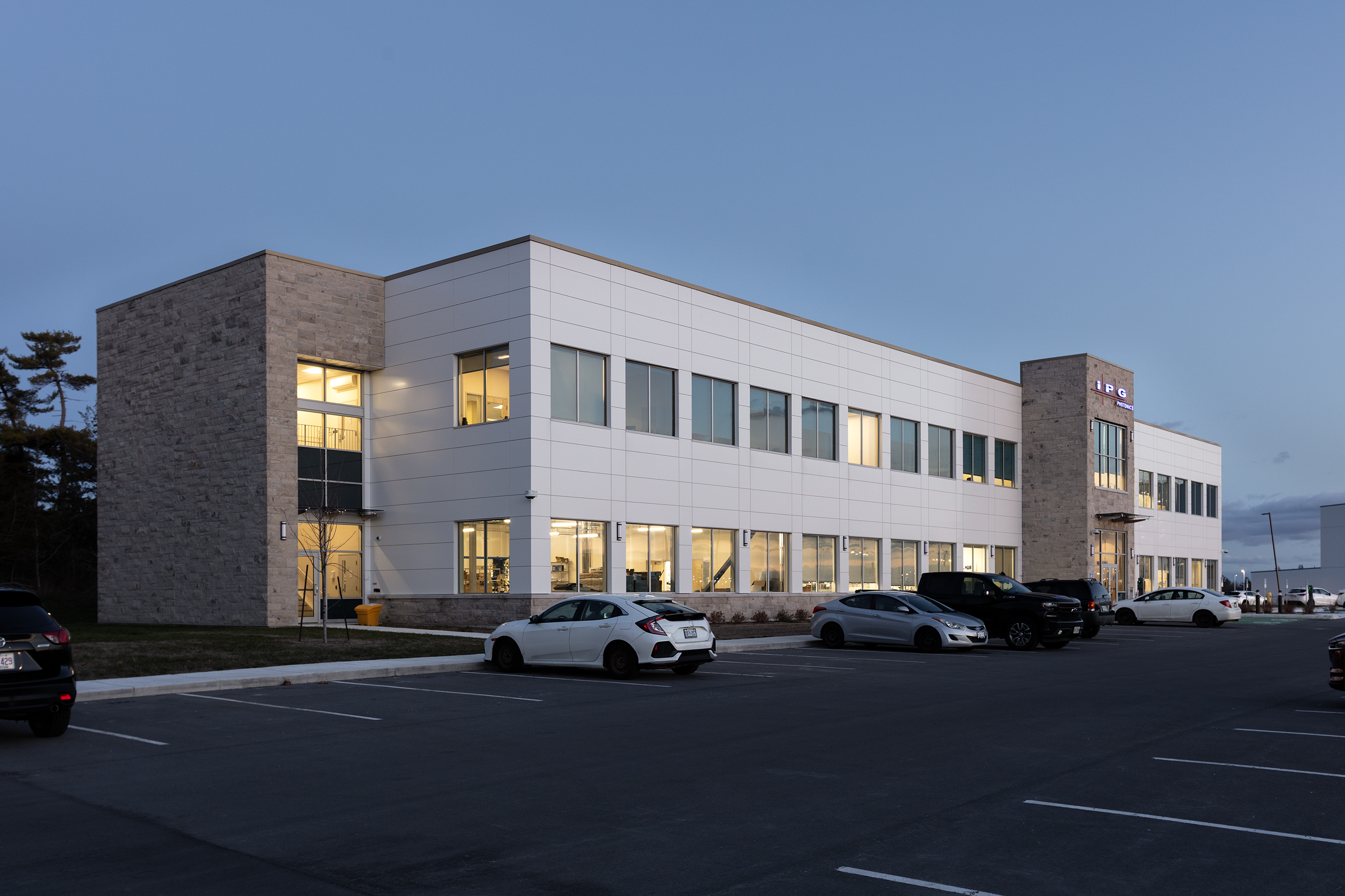 A modern and contemporary industrial building wiht a mix of brick and stone on the facade. 