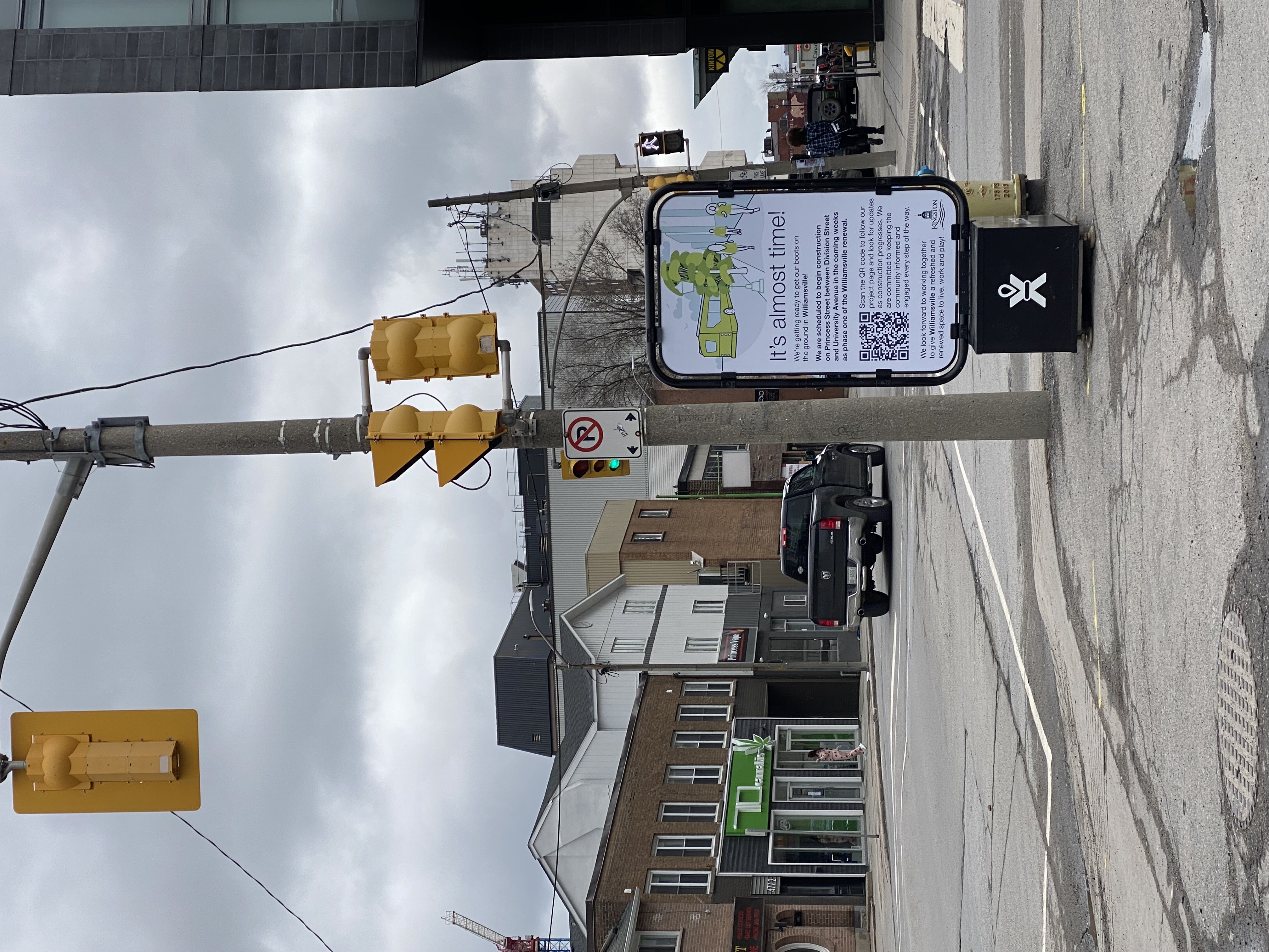 A view looking east down Princess Street at University Avenue. On the corner is a Curbex sign saying "It's almost time!"