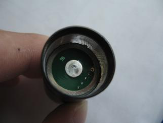 Cleaning inside of flashlight head with cotton swab