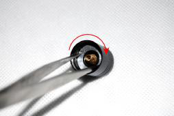 Using forceps to tighten tailcap retaining ring