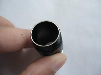 Cleaning inside of flashlight body tube with cotton swab