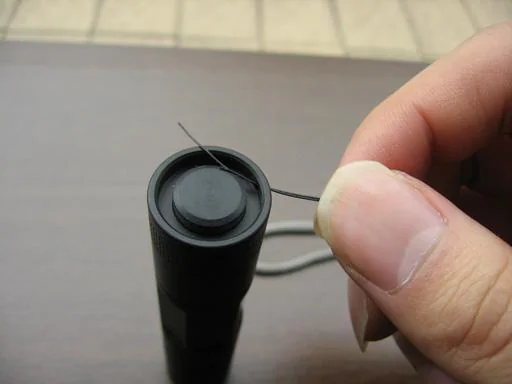 Threading filament through tailcap lanyard hole