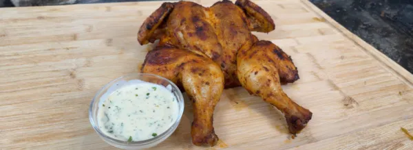 Flattened chicken with a parmesan sauce