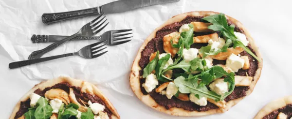 SHISH TAOUK CHICKEN PIZZA WITH CREAMY OLIVE AND BASIL PESTO, GOAT CHEESE, AND ARUGULA