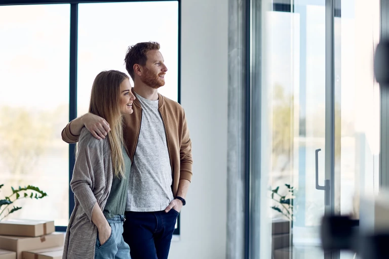New homeowners looking out window