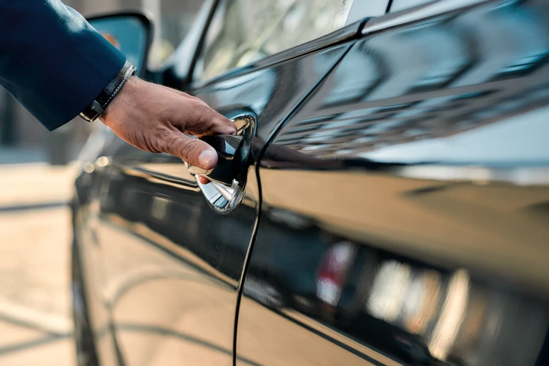 Hand opening a car door