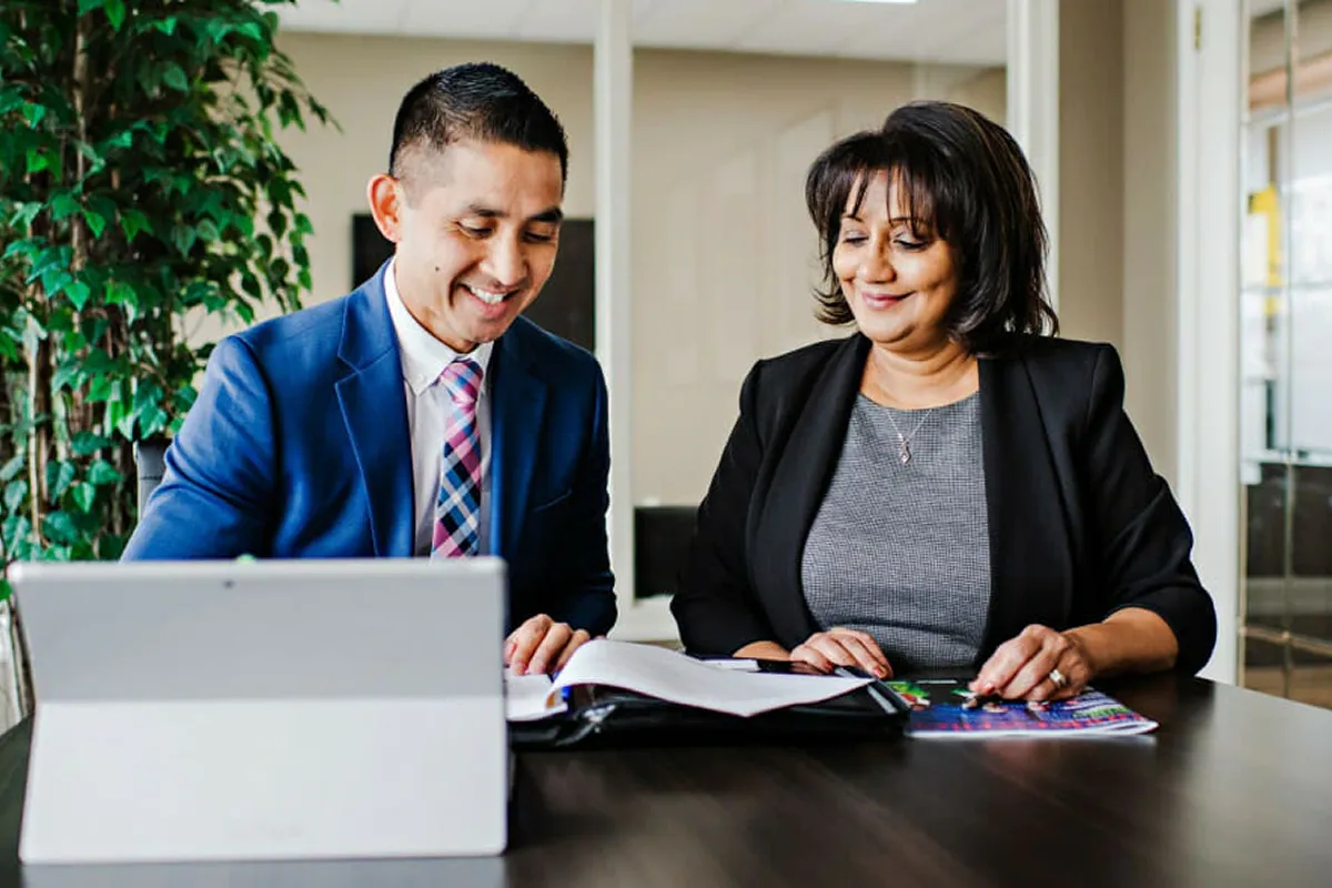 A man and a woman looking at papers