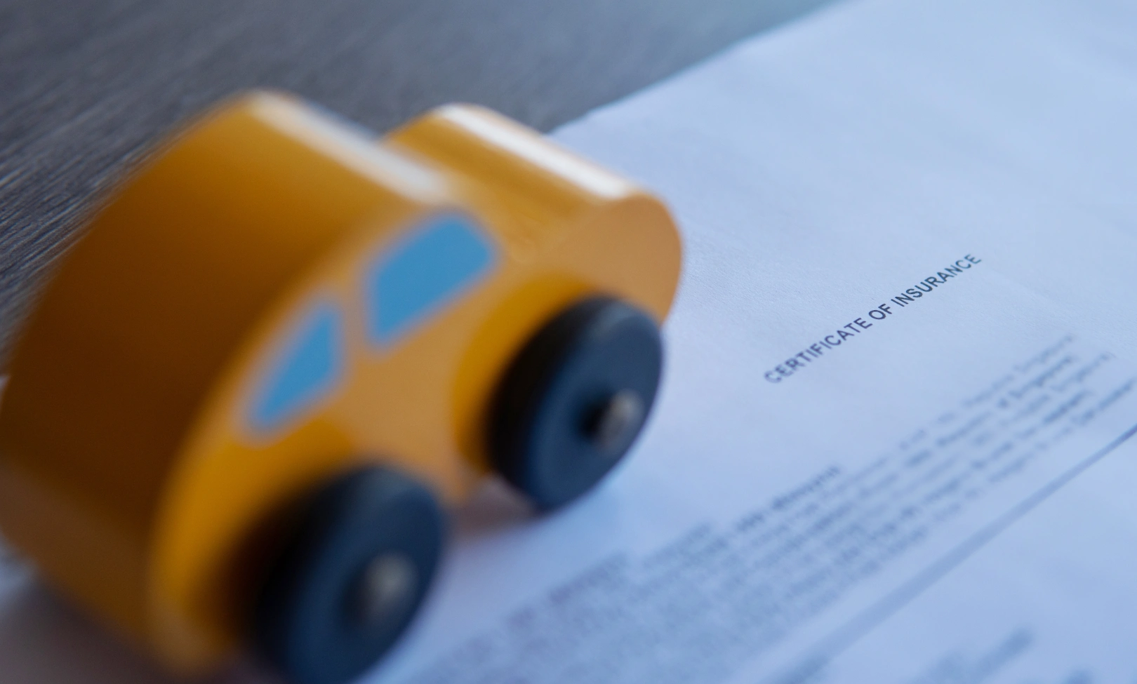 Toy car on insurance documents