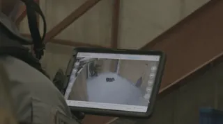 Operator reviewing camera feed on iPad during training