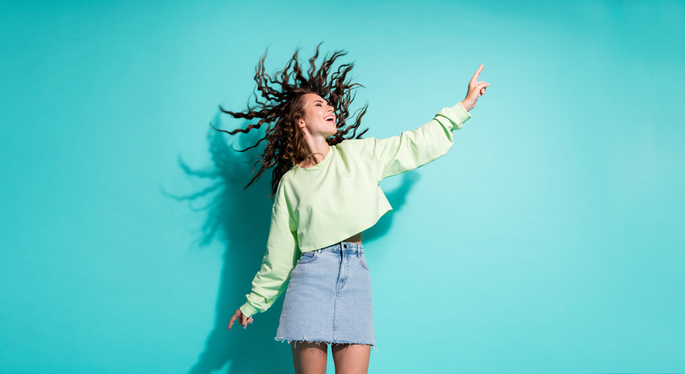 Thrifting Fashion Trends for Spring/Summer 2022 4 Woman dancing in a micro skirt she bought at a thrift store in Alberta