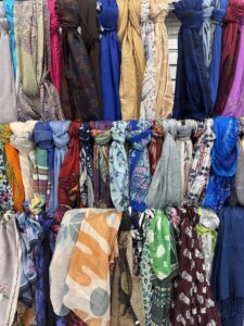 Colourful scarves displayed on racks at Goodwill SouthPark in Edmonton