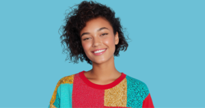 Woman wearing upcycled patchwork sweater created using thrifted items from Goodwill