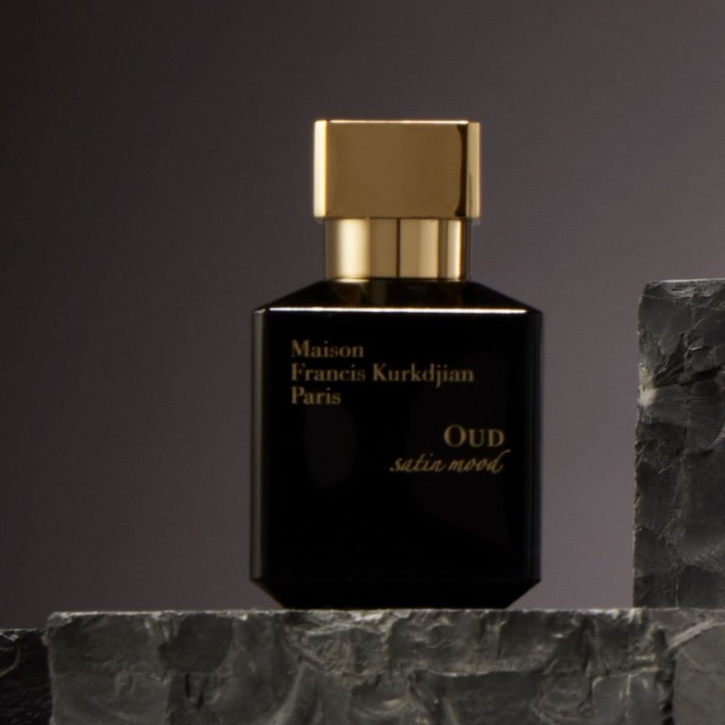 Black perfume bottle with chunky gold topper.