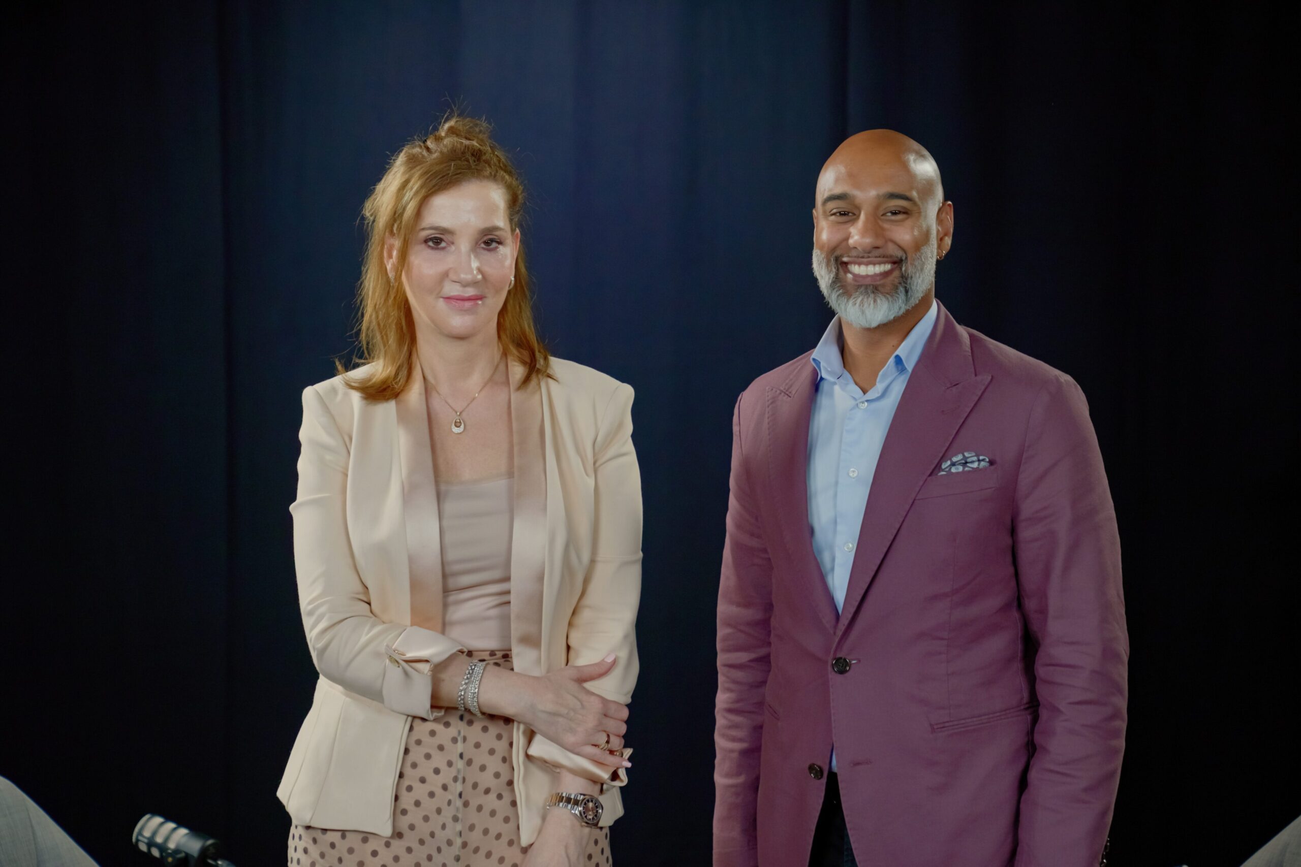 Dr. Dima Jamali and a colleague posing in a studio setting, featured in the Third Culture Leaders podcast episode on leadership and resilience.