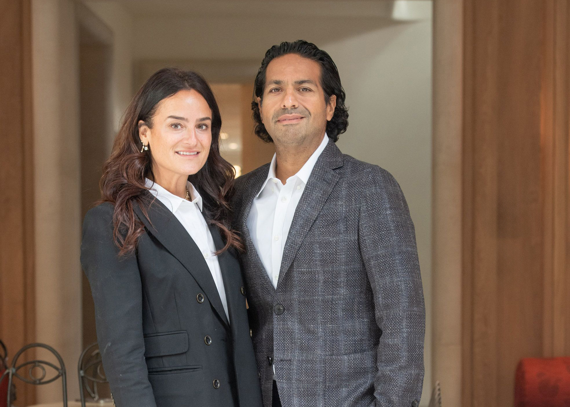 Moez and Marissa Kassam, co-founders of the Moez and Marissa Kassam Equity Fund, posing together in a professional setting, emphasizing their commitment to philanthropy and strategic investment in business.