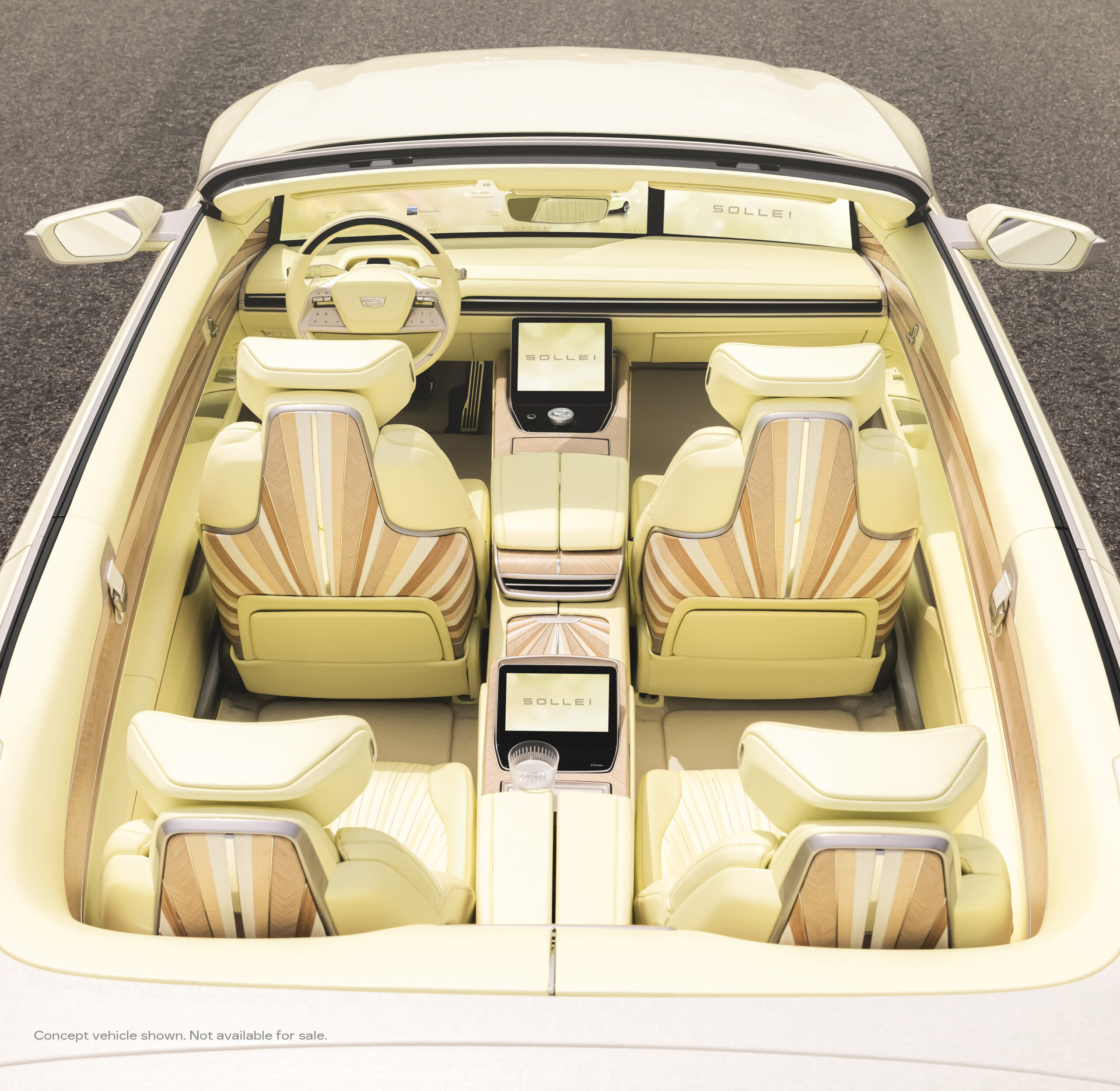 Interior view of a luxurious concept car featuring a light yellow and wood design, with prominent digital displays and the logo "SOLLEI" visible on the center console.