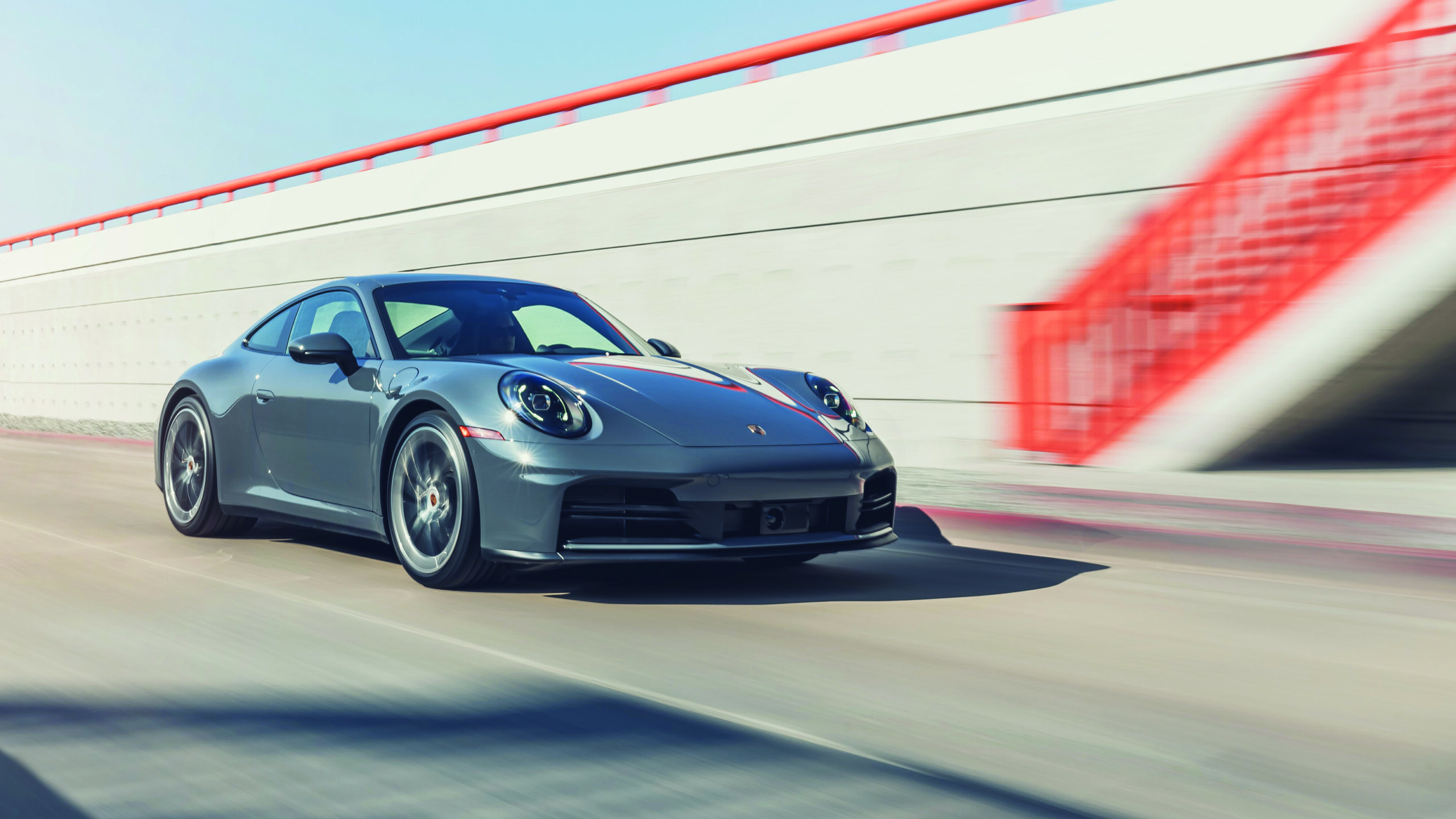 Porsche sports car in motion on a sleek urban road, showcasing luxury automotive design and performance, relevant to the lifestyle and motors themes in Matt Bubbers' articles.