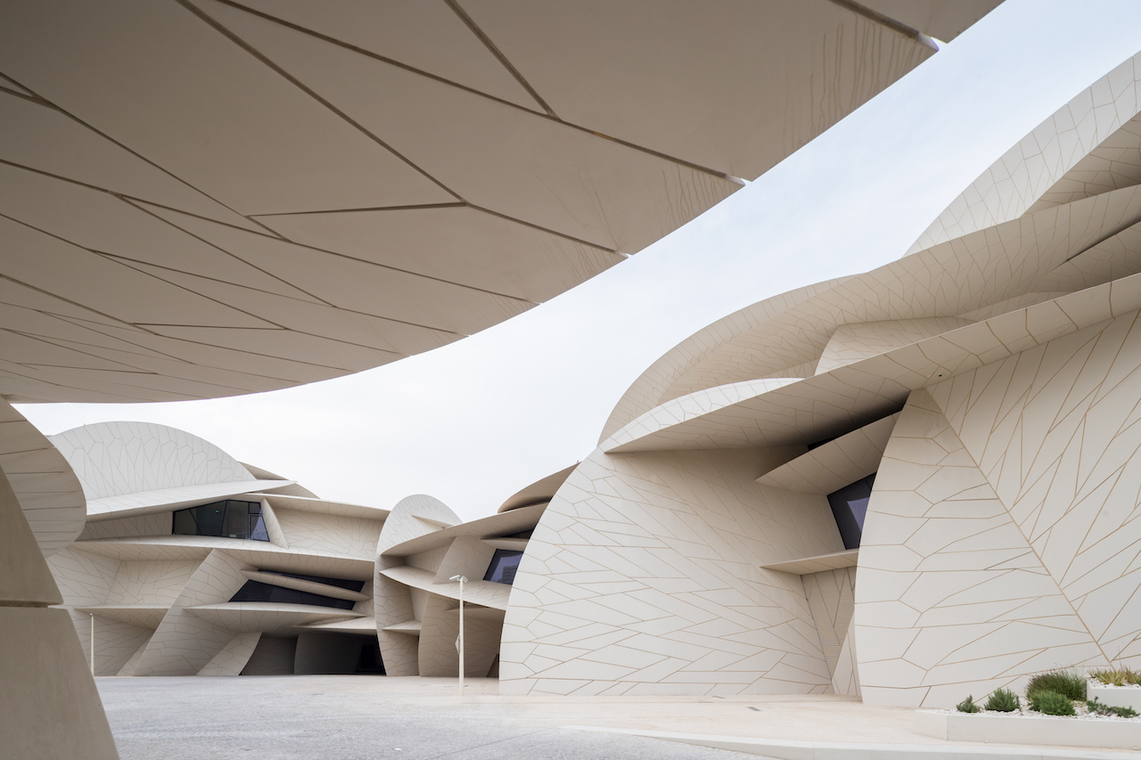 Modern architectural design of the National Museum of Qatar, featuring intricate geometric patterns and organic shapes, highlighting Qatar's evolving cultural landscape.