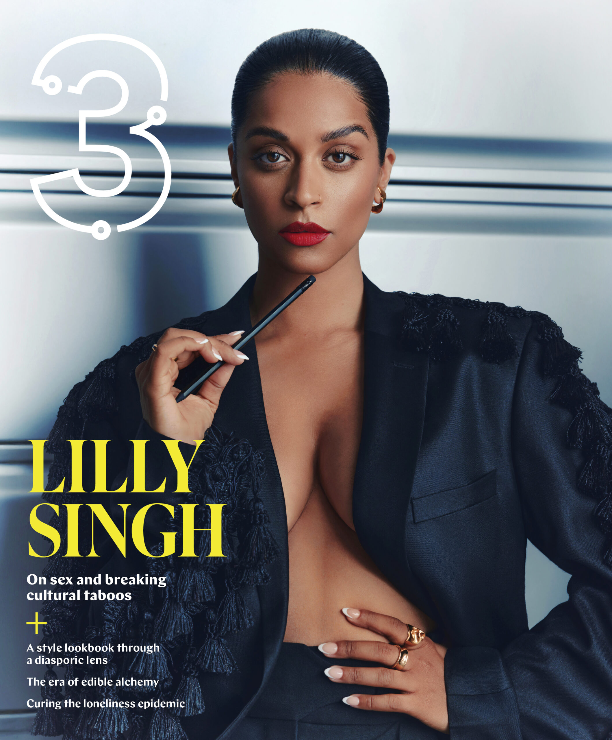 Lilly Singh on magazine cover, wearing a black blazer with decorative tassels, holding a pen, featuring bold text about breaking cultural taboos and sexuality, reflecting themes of connection and identity.