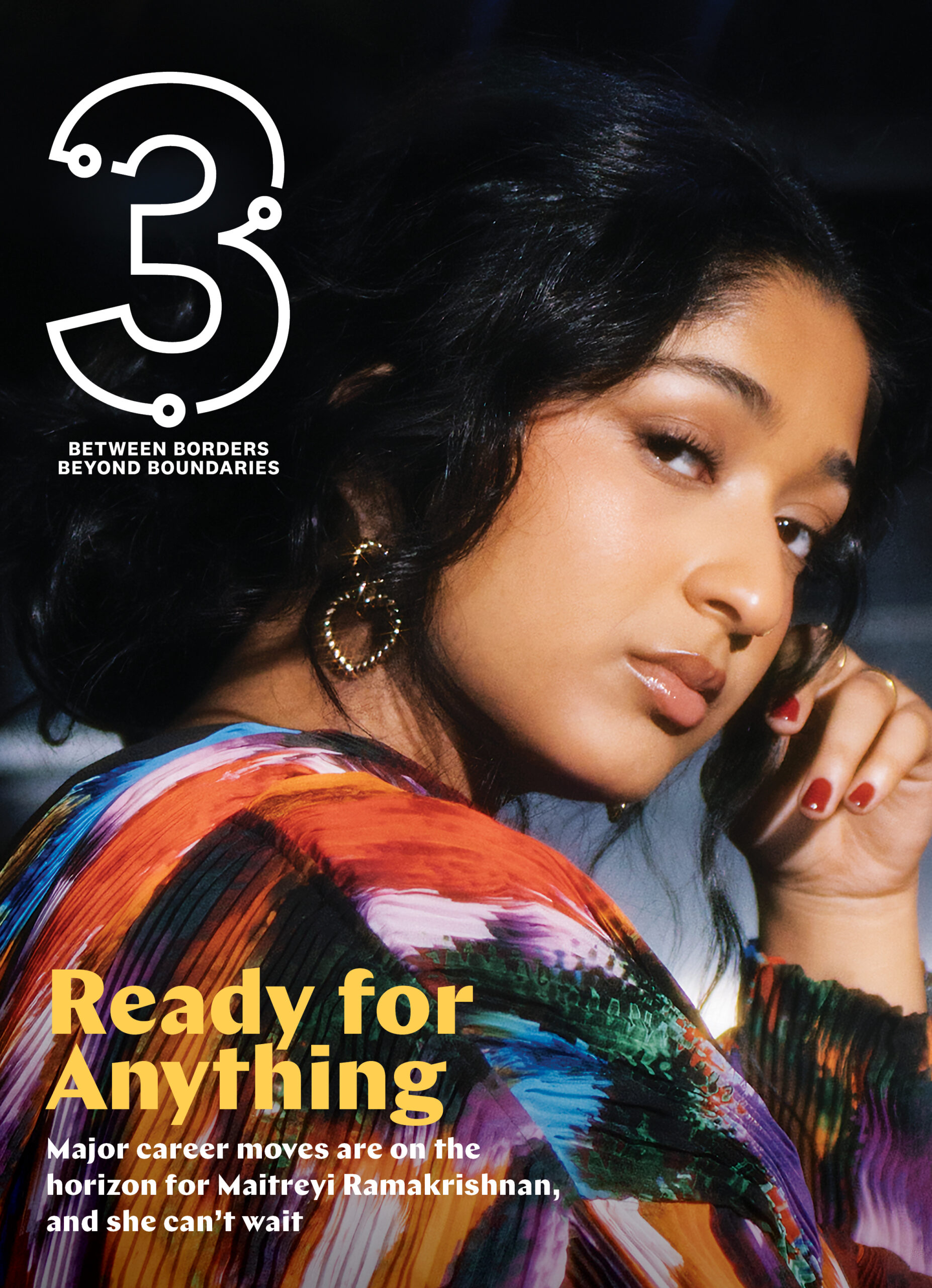 Maitreyi Ramakrishnan gazing confidently at the camera, wearing a colorful patterned top, with bold text overlay reading "Ready for Anything," symbolizing her readiness for upcoming career opportunities, featured on the cover of Three Magazine, themed around cultural exploration and identity.