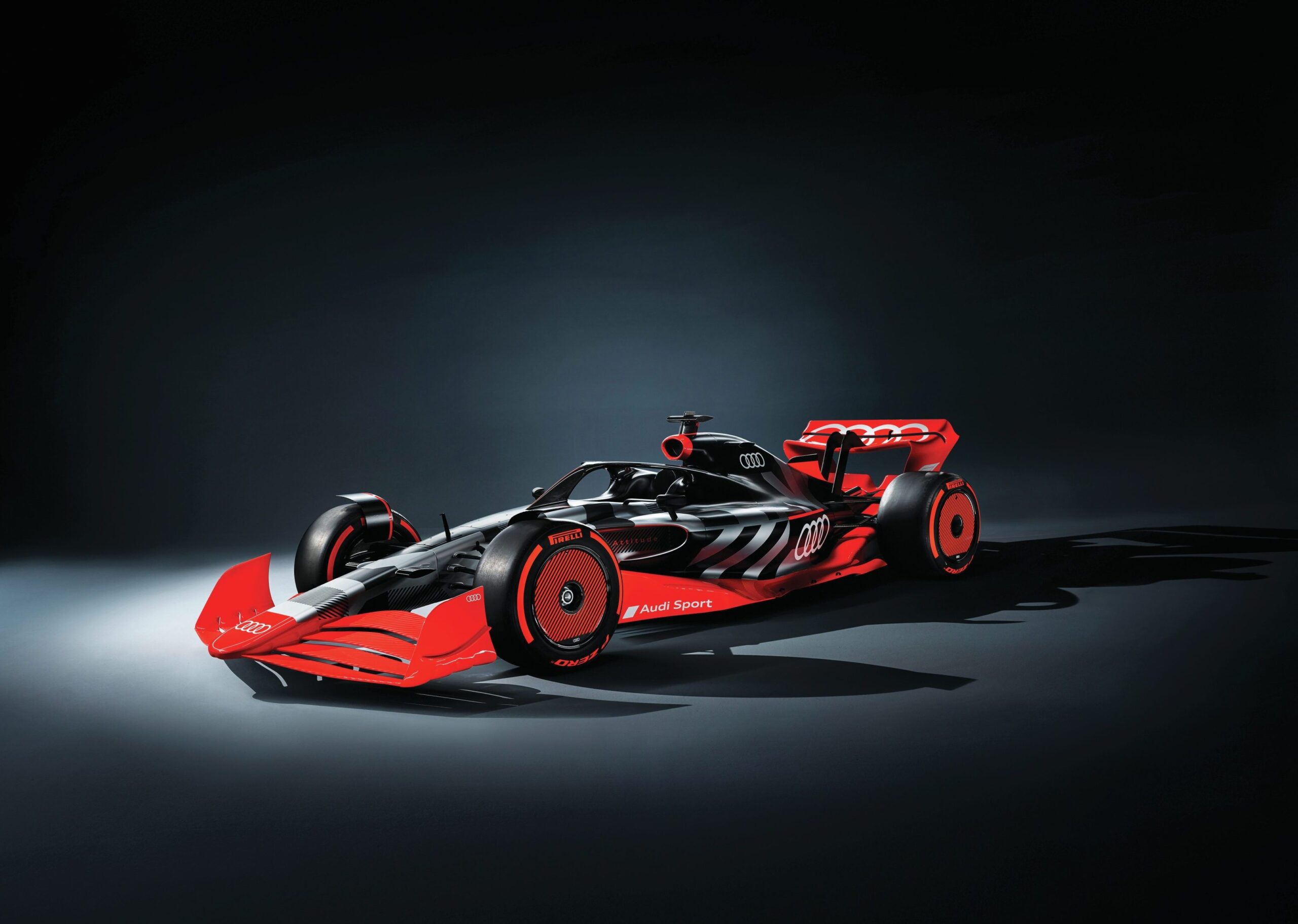 Formula 1 red race car against a black backdrop.