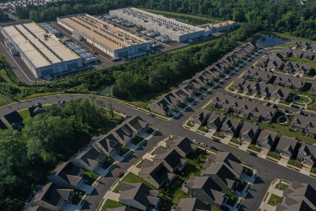 An aerial view of an Amazon Web Services data center close to a residential area. 