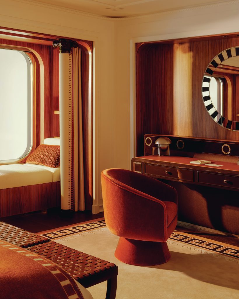 Bedroom suite on a yacht with dark wood accents.