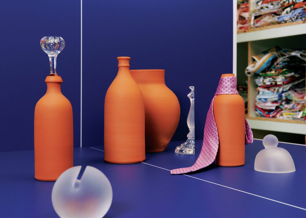 Terracotta vases and decorative crystal decor against a dark blue background.