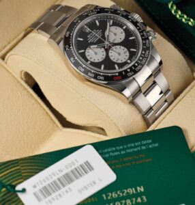 Rolex Cosmograph Daytona luxury watch in display box with authentication card, highlighting the importance of condition and authenticity in the second-hand luxury watch market.