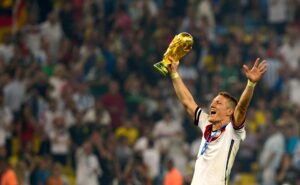 Bastian Schweinsteiger celebrating with the FIFA World Cup Trophy after Germany’s 2014 World Cup win.